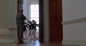 Movie still from “Billy Elliot” (2000), directed by Stephen Daldry – A group of young ballerinas are lined up against a door; Wide shot, Low angle