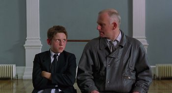 Movie still from “Billy Elliot” (2000), directed by Stephen Daldry – A man and a young boy sitting next to each other; Medium shot, Over the shoulder angle