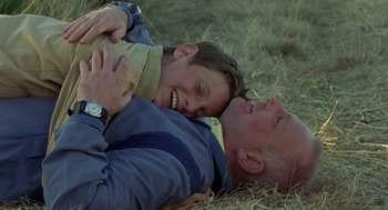 Movie still from “Billy Elliot” (2000), directed by Stephen Daldry – An older man and a young boy laying in the grass; Close Up shot, High angle