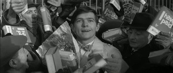 Movie still from “Billy Liar” (1963), directed by John Schlesinger – A black and white photo of a man surrounded by boxes; Close Up shot, High angle