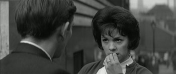 Movie still from “Billy Liar” (1963), directed by John Schlesinger – An older woman is looking at a younger man; Close Up shot, Over the shoulder angle
