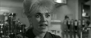 Movie still from “Billy Liar” (1963), directed by John Schlesinger – A person's face in a black and white photo; Close Up shot, Low angle