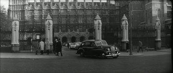 Movie still from “Billy Liar” (1963), directed by John Schlesinger – An old black and white photo of a vintage car; Extreme Wide shot, Low angle