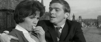 Movie still from “Billy Liar” (1963), directed by John Schlesinger – A man and a woman are eating some food together; Close Up shot, High angle