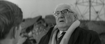 Movie still from “Billy Liar” (1963), directed by John Schlesinger – An old man wearing glasses and a tie; Close Up shot, Low angle