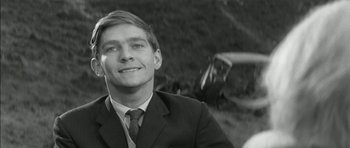 Movie still from “Billy Liar” (1963), directed by John Schlesinger – Black and white photograph of a man in a suit and tie; Close Up shot, Low angle