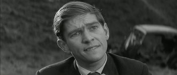 Movie still from “Billy Liar” (1963), directed by John Schlesinger – Black and white photograph of a man in a suit; Close Up shot, High angle