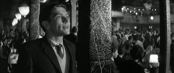 Movie still from “Billy Liar” (1963), directed by John Schlesinger – A black and white photo of a man in a suit and tie; Close Up shot, Low angle