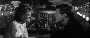 Movie still from “Billy Liar” (1963), directed by John Schlesinger – A man and a woman talking to each other in front of an audience; Close Up shot, Low angle