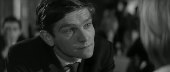 Movie still from “Billy Liar” (1963), directed by John Schlesinger – Black and white photograph of a man in a suit; Close Up shot, High angle
