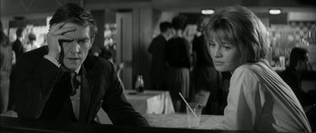 Movie still from “Billy Liar” (1963), directed by John Schlesinger – A man and a woman sitting at a table in a restaurant; Medium shot, Over the shoulder angle