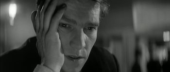 Movie still from “Billy Liar” (1963), directed by John Schlesinger – A person holding his hand up to his forehead; Close Up shot, High angle