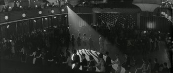 Movie still from “Billy Liar” (1963), directed by John Schlesinger – A black and white photo of people dancing in a ballroom; Extreme Wide shot, High angle