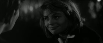 Movie still from “Billy Liar” (1963), directed by John Schlesinger – A black - and - white photo of a woman smiling; Close Up shot, Over the shoulder angle