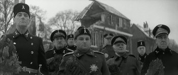 Movie still from “Billy Liar” (1963), directed by John Schlesinger – A black and white photo of a group of men in military uniforms; Medium shot, Low angle