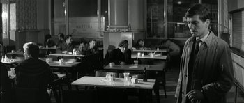 Movie still from “Billy Liar” (1963), directed by John Schlesinger – A group of people sitting at tables in a restaurant; Wide shot, High angle