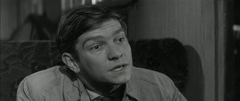 Movie still from “Billy Liar” (1963), directed by John Schlesinger – Black and white photograph of a man in a shirt and tie; Close Up shot, Low angle