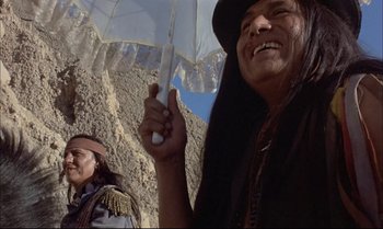 Movie still from “Billy Two Hats” (1974), directed by Ted Kotcheff – Two native american men holding an umbrella in the mountains; Close Up shot, Low angle