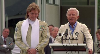 Movie still from “Bio-Dome” (1996), directed by Jason Bloom – Two men standing next to each other in front of microphones and microphones; Medium shot, Low angle