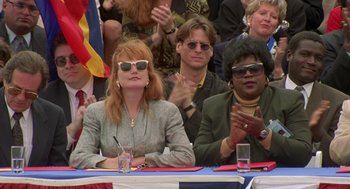 Movie still from “Bio-Dome” (1996), directed by Jason Bloom – A group of people sitting at a table; Medium shot, Low angle