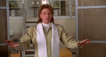 Movie still from “Bio-Dome” (1996), directed by Jason Bloom – A man with long brown hair wearing a white scarf; Close Up shot, Low angle