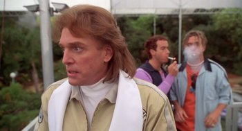 Movie still from “Bio-Dome” (1996), directed by Jason Bloom – A person with long brown hair; Close Up shot, Low angle