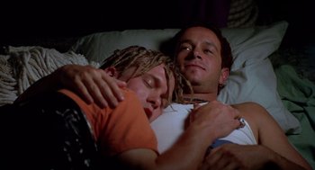 Movie still from “Bio-Dome” (1996), directed by Jason Bloom – Two people laying in a bed with one of them sleeping; Close Up shot, High angle