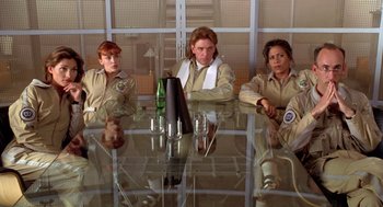 Movie still from “Bio-Dome” (1996), directed by Jason Bloom – A group of women sitting at a glass table; Medium shot, Low angle