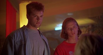 Movie still from “Bio-Dome” (1996), directed by Jason Bloom – A man and a woman standing next to each other; Close Up shot, Low angle