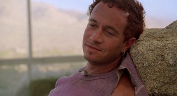 Movie still from “Bio-Dome” (1996), directed by Jason Bloom – A person wearing a purple shirt; Close Up shot, Over the shoulder angle