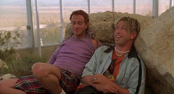 Movie still from “Bio-Dome” (1996), directed by Jason Bloom – A couple of men sitting next to each other on top of a couch; Medium shot, Low angle
