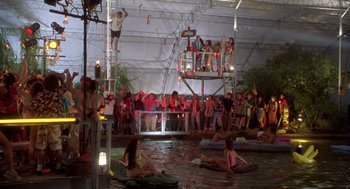 Movie still from “Bio-Dome” (1996), directed by Jason Bloom – A group of people sitting in a pool of water; Extreme Wide shot, High angle