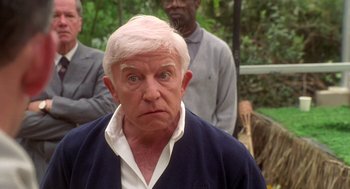 Movie still from “Bio-Dome” (1996), directed by Jason Bloom – An older man with a white hair and blue eyes; Close Up shot, Low angle