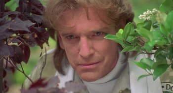 Movie still from “Bio-Dome” (1996), directed by Jason Bloom – A person wearing a white shirt; Close Up shot, Over the shoulder angle