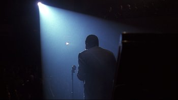 A man standing on a stage holding a microphone