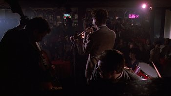 A group of people in a room playing musical instruments