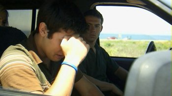 Movie still from “Birdemic: Shock and Terror” (2010), directed by James Nguyen – Two young men sitting in the back seat of a car; Close Up shot, Over the shoulder angle