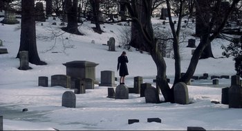Movie still from “Birth” (2004), directed by Jonathan Glazer – A woman standing in the snow in a cemetery; Extreme Wide shot, High angle