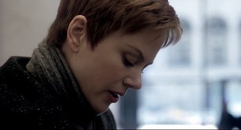 Movie still from “Birth” (2004), directed by Jonathan Glazer – A person with short brown hair; Close Up shot, Over the shoulder angle
