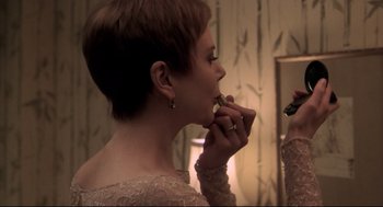 Movie still from “Birth” (2004), directed by Jonathan Glazer – A woman putting lipstick on in front of a mirror; Close Up shot, Over the shoulder angle