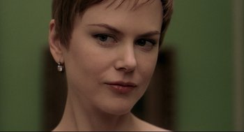 Movie still from “Birth” (2004), directed by Jonathan Glazer – A person with short brown hair; Close Up shot, Over the shoulder angle
