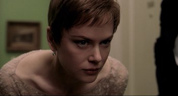 Movie still from “Birth” (2004), directed by Jonathan Glazer – A person with short brown hair; Close Up shot, Over the shoulder angle