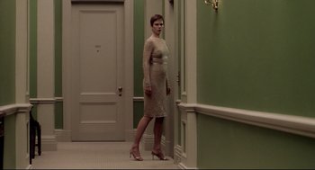 Movie still from “Birth” (2004), directed by Jonathan Glazer – A woman standing in a hallway wearing high heel shoes; Wide shot, Low angle