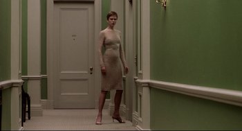 Movie still from “Birth” (2004), directed by Jonathan Glazer – A woman standing in a hallway wearing high heel shoes; Wide shot, Low angle
