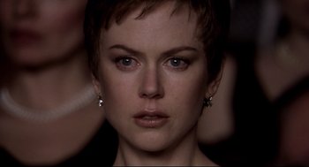 Movie still from “Birth” (2004), directed by Jonathan Glazer – A person with short hair; Close Up shot, Over the shoulder angle