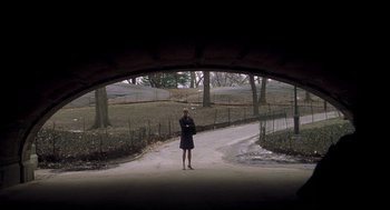 Movie still from “Birth” (2004), directed by Jonathan Glazer – A woman standing in a tunnel in a park; Extreme Wide shot, High angle