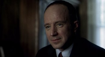 Movie still from “Birth” (2004), directed by Jonathan Glazer – A person wearing a suit and tie; Close Up shot, Over the shoulder angle