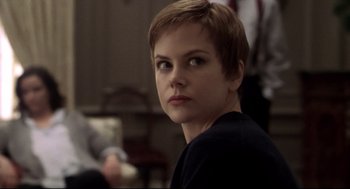 Movie still from “Birth” (2004), directed by Jonathan Glazer – A person with short brown hair; Close Up shot, Over the shoulder angle