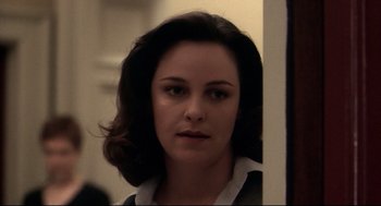 Movie still from “Birth” (2004), directed by Jonathan Glazer – A person wearing a shirt and tie; Close Up shot, Over the shoulder angle