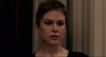 Movie still from “Birth” (2004), directed by Jonathan Glazer – A person with short brown hair; Close Up shot, Over the shoulder angle